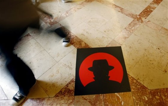 A man passes a logo of the Black Hat technology conference in Las Vegas on Wednesday, July 28, 2010.